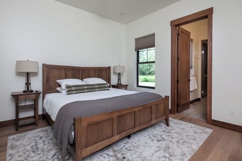 Settle into a warm wood bed with serene, quiet comfort.