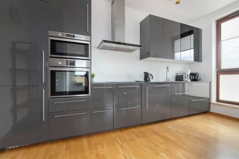 Another view of the modern kitchen showing the stovetop and cabinets. The area is sleek, organized, and ready for use.