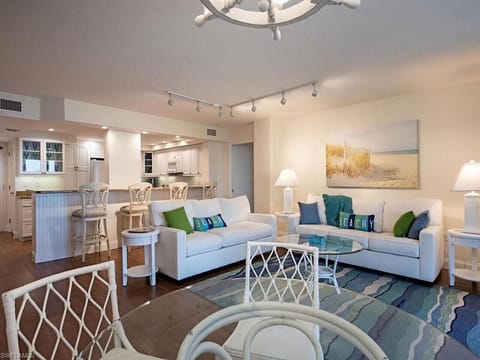 Dining area opens to the living room with cozy coastal furnishings