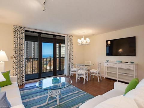 Bright coastal living room with private balcony steps from Vanderbilt Beac