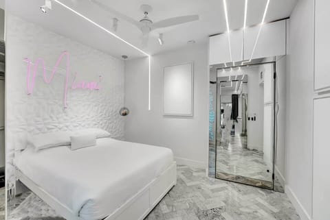 1st FLOOR:  features 1 queen + twin XL pullout trundle bed (sleeps 3). This room also features 2 custom neon signs. Hidden sliding mirrored door separates bedroom from living room / party lounge. Connected bathroom. Kohler fixtures. 