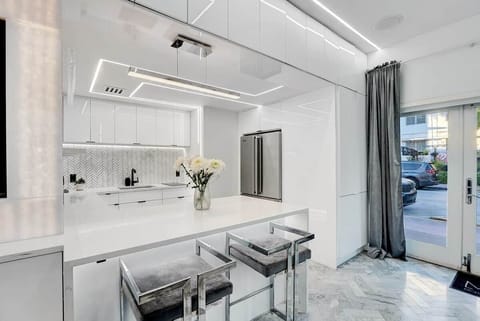 1st FLOOR: FULL BAR KITCHEN features full size Viking fridge, Viking drawer microwave, sink, ceiling mounted champaign flutes, and a bar for 2. Multicolor lights are controllable via remote. Hidden disco ball reveals from upper cabinets via remote. 