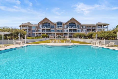 A pristine swimming pool creates the perfect centerpiece for this elegant beachfront resort property.