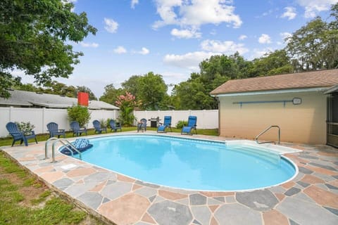 The pool area is fully fenced. Grill near the fence corner.