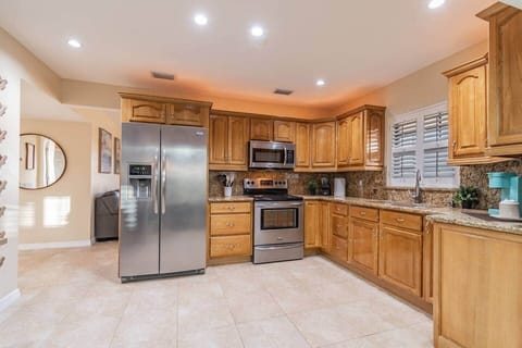 Fully equipped kitchen includes microwave, refrigerator, stove, oven, & more