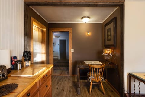 Kitchen Features reclaimed pine wood cabinetry and handmade pine countertops, combining rustic charm with functionality. Fully equipped with a sink, refrigerator, stove, coffee maker, olive oil, salt, pepper, silverware, cookware, dishes, and wine glasses