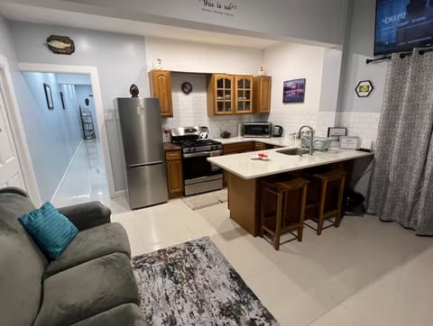 Modern kitchen open to cozy living space.