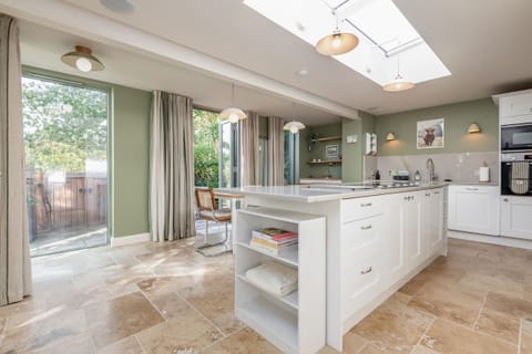 Open-plan kitchen with skylights, island unit and garden views in St Andrews holiday home.
