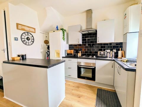 A clean, fully equipped kitchen with modern finishes and everything you need to dine in style.