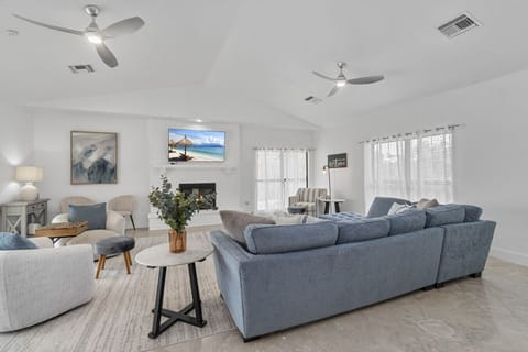 Gather in the bright living room with cozy seating for the whole family.