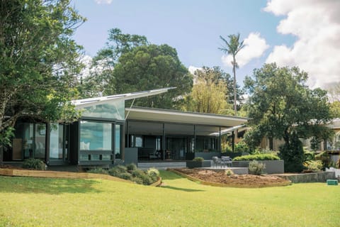 Striking modern exterior with sharp architectural lines and floor-to-ceiling windows.