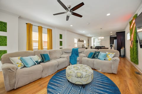 A bright, open living space with sectional sofa and colorful accents.