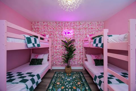 Instagram-worthy fun with pink decor and vibrant floral walls for unforgettable stays!