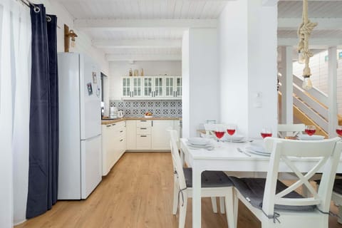 A dining table set with red drinks and pastries, ready for a meal.