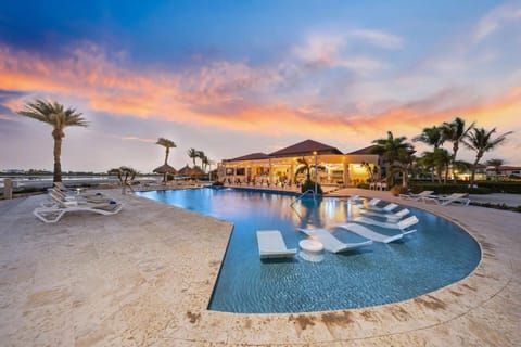 Resort-style pool with loungers and evening ambiance.