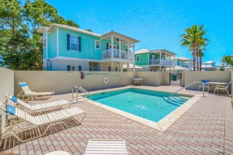 A gated community pool right next to the house, offering easy access to a refreshing swim and a fun spot to relax without having to go far offering added security and piece of mind!