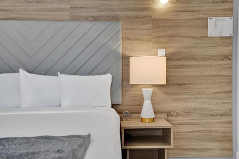 Drift off under soft lamplight and a plush headboard.