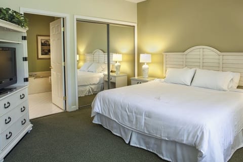 Unwind in crisp linens with calming lamps and quiet comfort.
