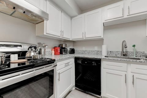 Kitchen overview w/ modern appliances and clean finishes designed for everyday meals.