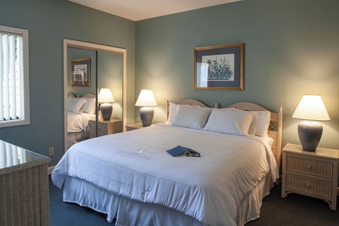 Recharge in a calm, spacious bedroom with warm lamplight.