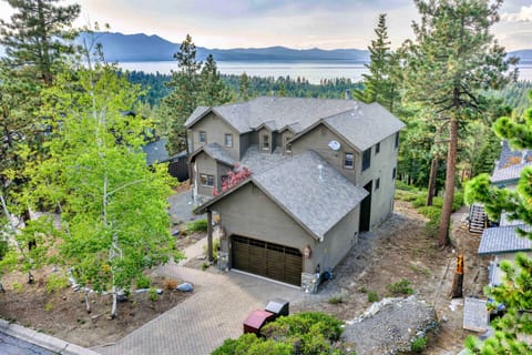 Exterior: On-site parking for 4 vehicles (2 in garage, 2 in driveway), multiple decks with lake views, gas grill, outdoor dining