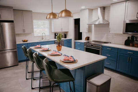 Our fully stocked kitchen features high-end appliances and a large island with high seating — perfect for cooking up feasts, sipping morning coffee, or sharing laughs while you prep meals.

