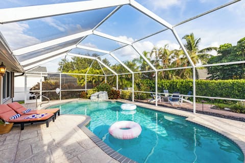 Sparkling screened-in pool and lounge seating.