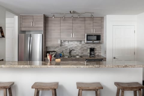 The kitchen at Smuggler Mine features stainless steel appliances and granite countertops