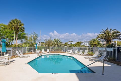 Your on-site swimming pool features comfortable loungers and tropical views