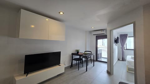 Apartment, Balcony, City View | Living area | Flat-screen TV