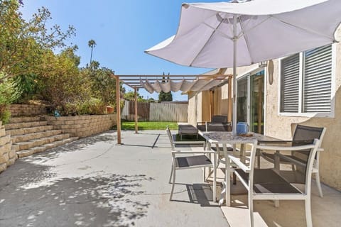 Relax in our sunny backyard patio, featuring a dining area