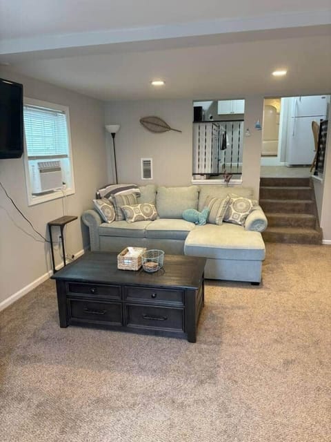 Unwind in the cozy living space with a coastal modern touch. Sink into the comfortable seating, and enjoy how the open layout flows seamlessly into the kitchen and sleeping area, making it an inviting spot to gather, recharge, and feel at home.
