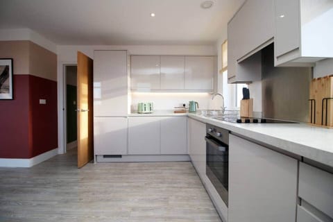 A sleek, fully equipped kitchen with contemporary units, generous worktop space,