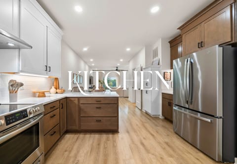 Modern kitchen with granite counters, stainless steel appliances, and bright finishes.