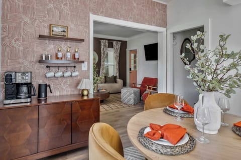 Step into a space designed for connection. This open-concept area effortlessly combines a gourmet coffee bar and a chic dining space, creating the perfect setting for everything from morning chats to late-night laughs.