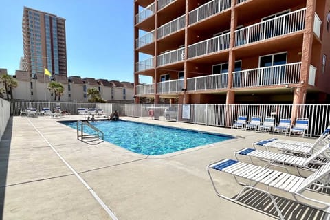 Beachfront pool deck with loungers.