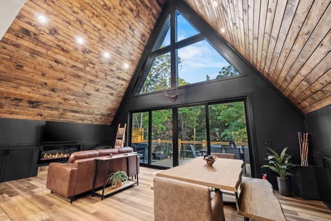 Expansive forest views from the living and dining room with wall of doors that opens to the back deck