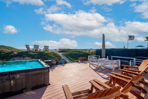 Deck area with private beach entrance, hot tub, fire pit, bbq and toys etc.