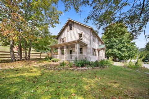 Classic farmhouse charm tucked under mature trees in Banner Elk. The covered front porch welcomes you home.