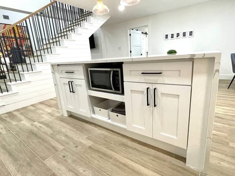 Microwave and extra dish towels located in kitchen island