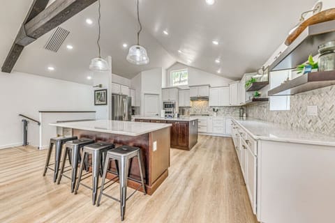 Kitchen | Expansive, modern design with a large island, pendant lighting, and sleek finishes