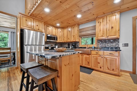 Rustic kitchen with modern appliances and a central island, great for meal prep.