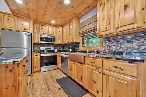 Rustic wood-finished kitchen with modern appliances and ample counter space.