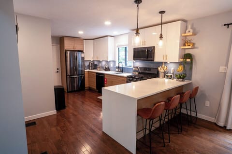 Open kitchen with large island seating and sleek design.