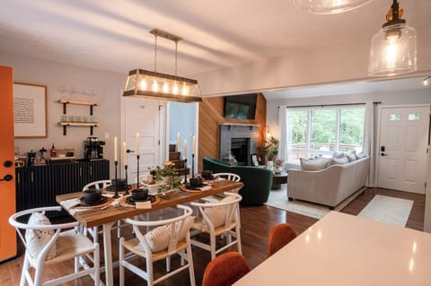 Open dining and living with fireplace and views.