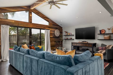 Living room 1 with ceiling fan, TV, large windows