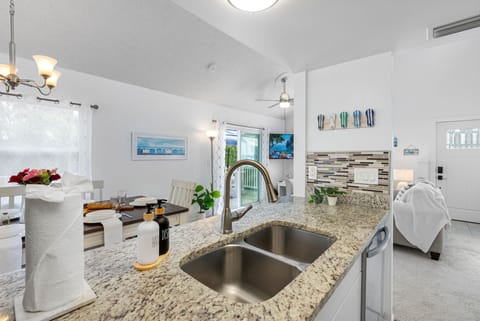 Granite counters and a modern backsplash give this kitchen a fresh, coastal-inspired look.