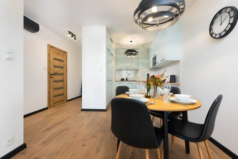 Cozy Dining Area with Stylish Table Setup and Direct Access to a Modern Kitchen | Book Now with RENTUJEMY.COM