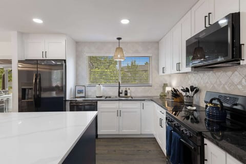 The kitchen has brand-new appliances including a dishwasher, oven, stove, microwave, refrigerator and coffee maker.