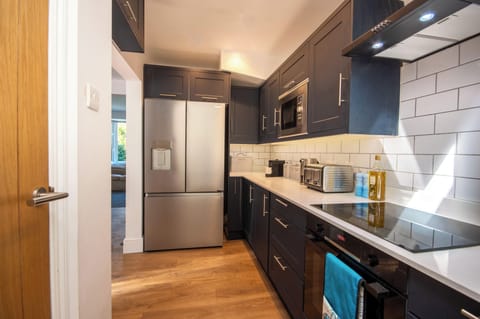 Kitchen with hob, oven, microwave, American fridgefreezer and dishwasher